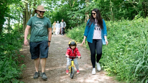 A family exploring a woodland path at Foremark, Derbyshire